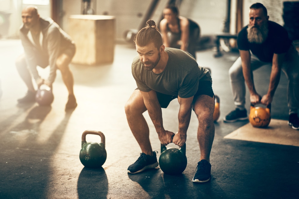 Group-of-people-working-out-and-lifting-weights-in-fitness-class